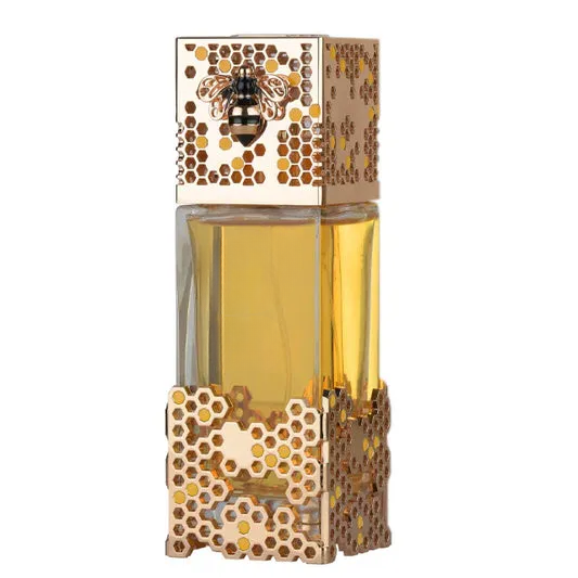 Empty decorative honeycomb glass bottle with bee motif, gold accents, for home decor