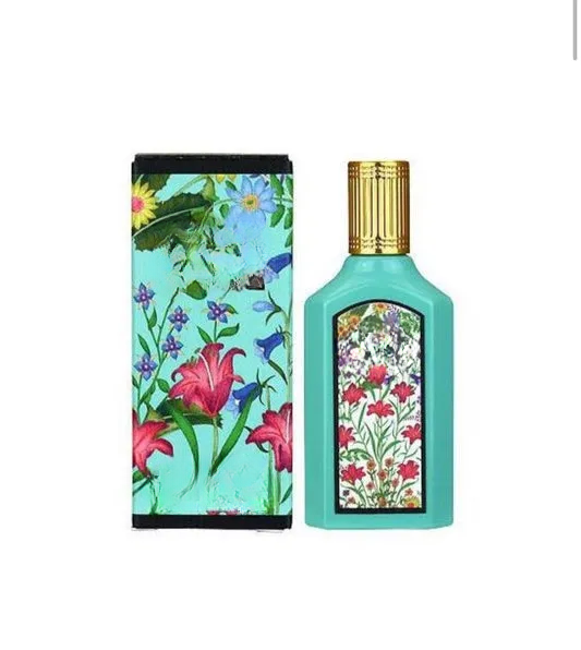 Empty decorative floral glass bottle with gold cap, perfect for home decor