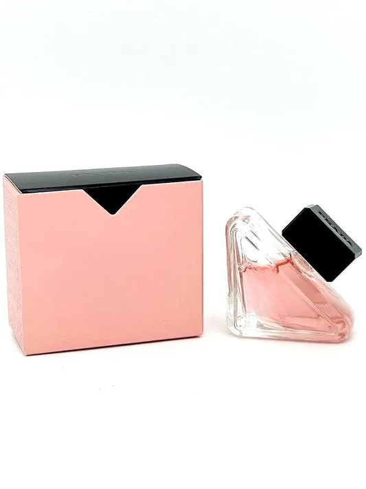 Empty decorative glass bottle with pink hue, sleek black cap, ideal for home decor styling