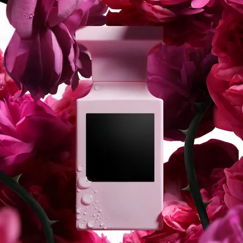 Empty decorative pink bottle surrounded by vibrant roses, ideal for home decor styling