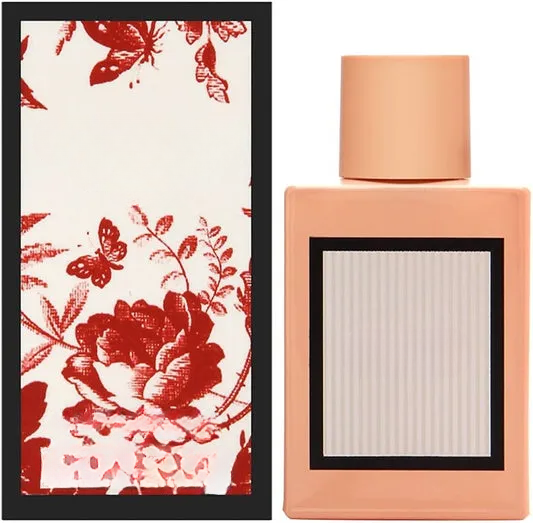 Empty decorative peach glass bottle with floral box, home decor accent