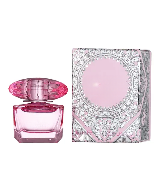 Pink decorative empty glass bottle with ornate cap, ideal for home decor