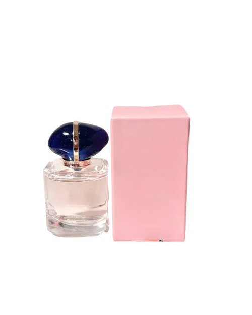 Empty decorative glass bottle with blue cap, pink box, home decor accent piece