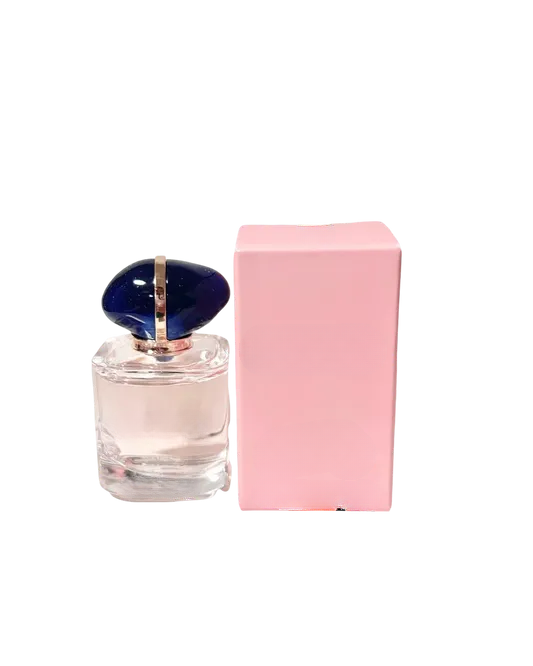 Empty decorative glass bottle with blue cap, pink box, home decor accent piece